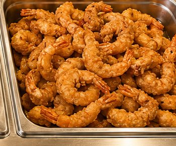 Fried shrimp in a steam-table pan